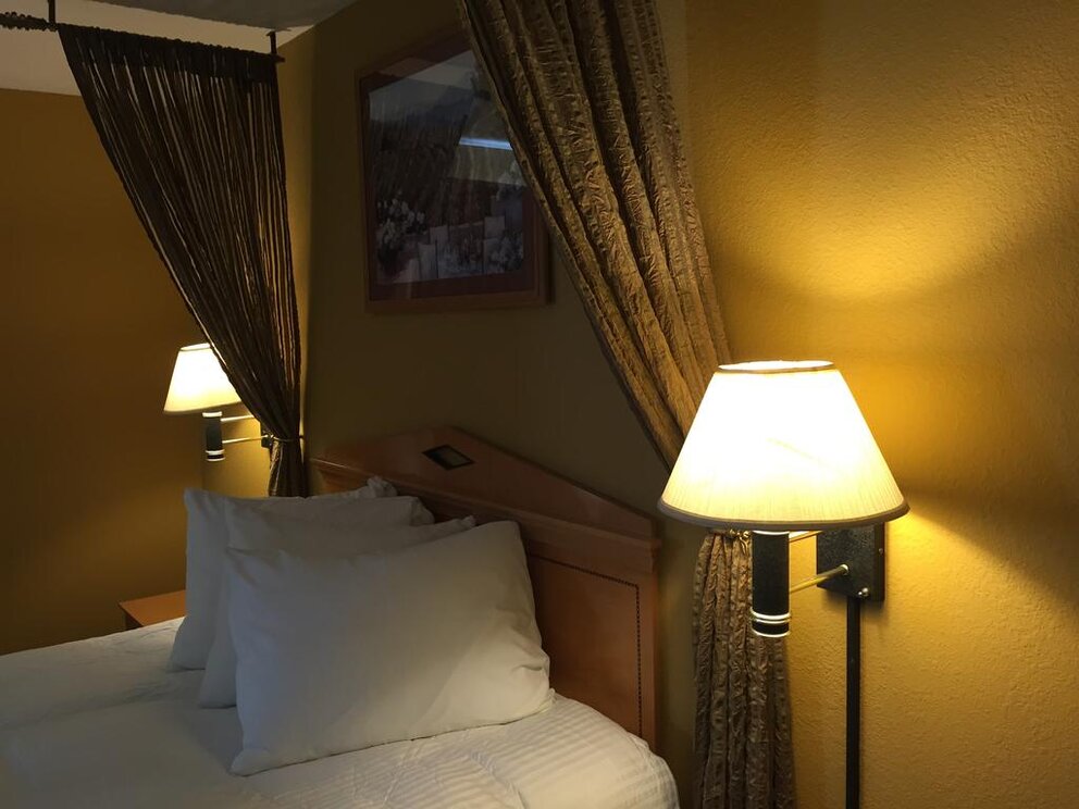 lamp by bed in hotel room